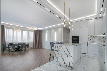 The modern kitchen and dining area are elegantly decorated with stylish furniture and 
natural...