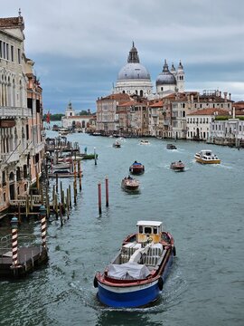 Venice Grand Canal daytime view with boats and Basilica Santa Maria della Salute in the background