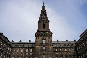 Fototapeta premium A grand historical building featuring prominent towers and spires, a key architectural landmark in Copenhagen, Denmark.