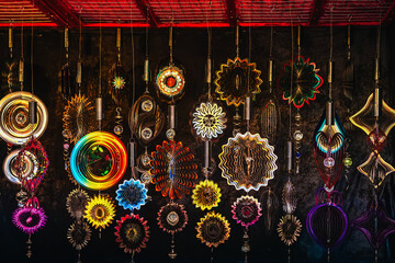 Wind spinners and art decor. Colorful metallic wind spinners and abstract hanging decorations shine...