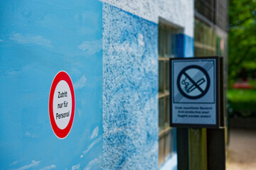 Blue wall with red circle staff only sign in German