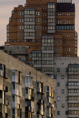 Cityscape view of mid-rise apartment complexes with brick and concrete facades, balconies, and...