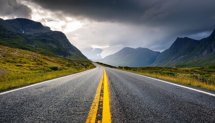 Naklejka premium a scenic road leading through mountains with vibrant yellow lines under a dramatic sky perfect for travel and adventure themes