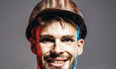 Builder man. Closeup portrait of male builder in protective helmet. Building industry and...