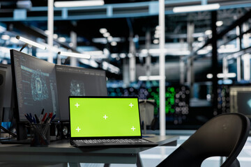 Green screen laptop in server room monitoring artificial intelligence visualizing neural networks data and analytics. Chroma key notebook overseeing servers powering machine learning operations
