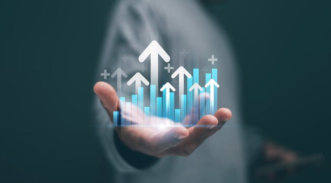 Business growth and success concept. Businessman showing growing graph and upward arrows. representing business growth. Financial success and performance improvement with digital data analytics.