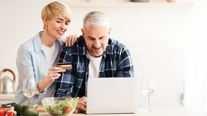 Joint purchases, online store, delivery service during pandemic. Happy adult woman and male look at...