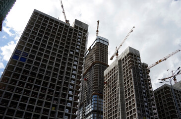 Construction of new residential buildings. Unfinished houses on the construction site.