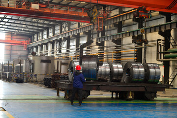 Workers on the production line of the strip steel coil factory are working