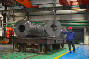Workers on the production line of the strip steel coil factory are working