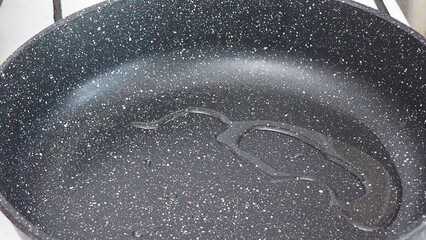 A woman fries vegetables in a frying pan at home. healthy food, diet, low calories, diet. cauliflower, green beans, peas, peppers, tomatoes. Vegetable saute in frying pan