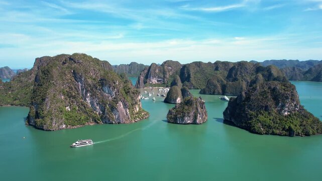 Ha Long Bay, Vietnam: Breathtaking aerial drone flight over Hạ Long Bay, panoramic view of iconic limestone karsts in emerald water - UNESCO landscape panorama of Southeast Asia from above
