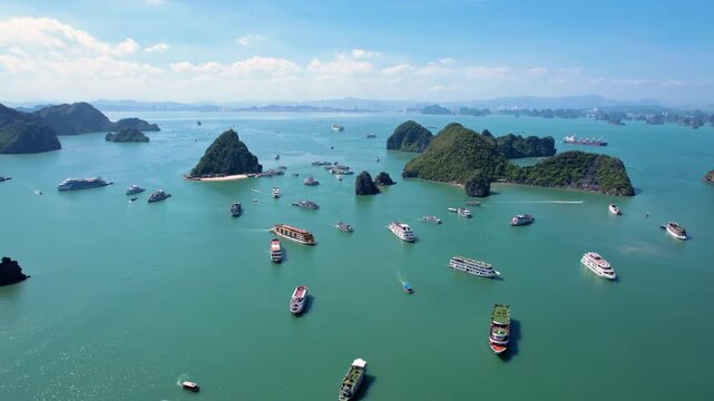 Ha Long Bay, Vietnam: Breathtaking aerial drone flight over Hạ Long Bay, panoramic view of iconic limestone karsts in emerald water - UNESCO landscape panorama of Southeast Asia from above
