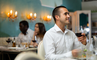Lonely male guest sitting at dinner in the restaurant