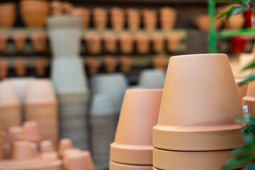 Rows with clay pots for plants in garden store