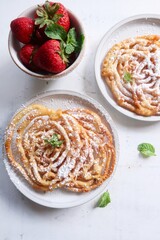 Homemade funnel cake topped with powdered sugar - summer carnival food