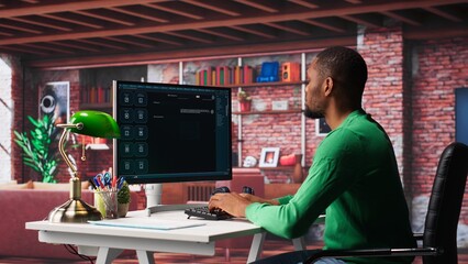 African american guy at home asks questions to AI chatbot virtual assistant, typing user prompts to generate information with the artificial intelligence tool. Machine learning. Camera A.