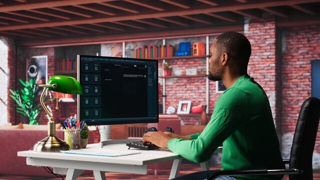 African american guy at home asks questions to AI chatbot virtual assistant, typing user prompts to generate information with the artificial intelligence tool. Machine learning. Camera A.