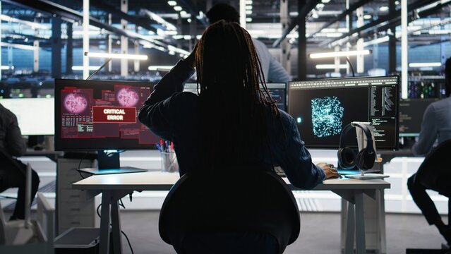 Stressed server hub admin worried by malfunctioning data analytics AI generator. Anxious data center worker concerned by critical error in artificial intelligence tool showing system metrics, camera A - Powered by Adobe