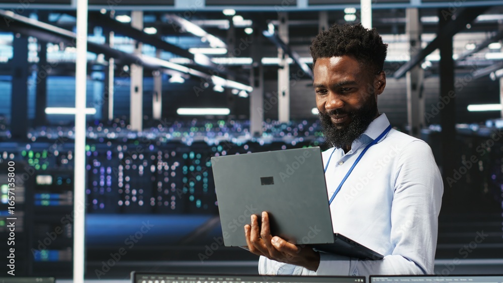 Poster happy data center admin uses node tree programming on laptop, doing high five with coworker. smiling
