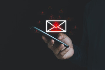 Cybersecurity concept with warning email alert on smartphone screen, representing phishing scam,...