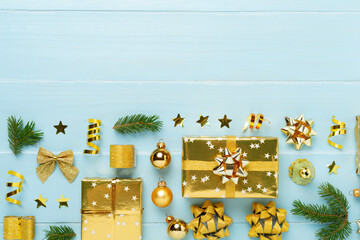 Handmade wrapped christmas gift boxes with stuff on wooden background, top view
