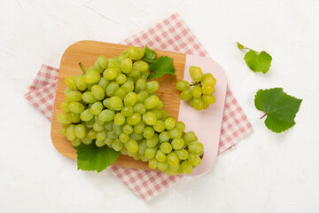 Fresh green grape on concrete background, top view