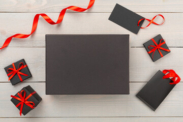 Mock up space with black gift boxes on wooden background, top view. Black Friday concept