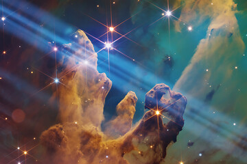 A view of the pillars of creation with stars and light beams in the background in outer space view