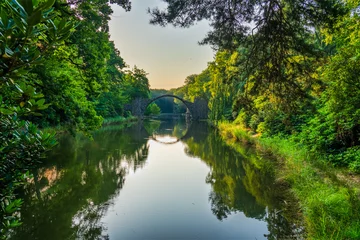 Wandcirkels Rakotzbrücke Rakotz Bridge (Rakotzbrucke, Devil's Bridge) in Kromlau, Saxony, Germany. Colorful summer, reflection of the bridge in the water create a full circle  © Pawel Pajor