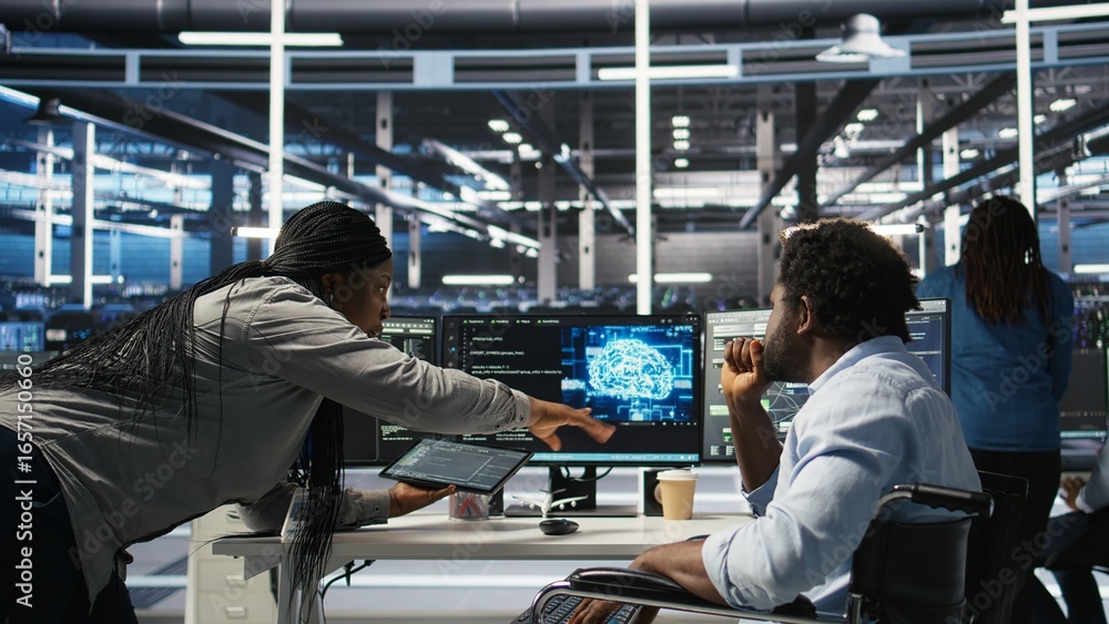 Poster admin in wheelchair and data center coworker working together using ai node tree software to minimiz