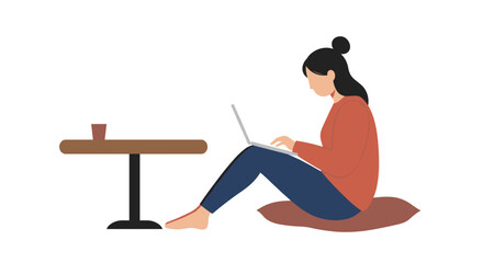Woman sits comfortably on a cushion, working on her laptop with a cup of coffee nearby. Represents remote work, freelancing, or casual study lifestyle.