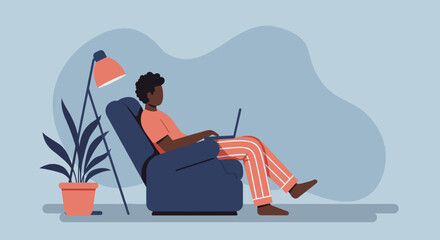 African American man relaxing comfortably in an armchair, working remotely on his laptop at home. Illustrates modern work-life balance and digital connectivity.