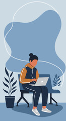 A person in casual wear works on a laptop in a modern waiting area, suitable for remote work, online education, or travel.