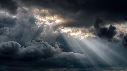Dramatic Cloud Patterns with Sunlight Rays Breaking Through Dark Skies Above Landscape