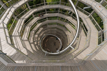A spiral staircase with a wooden floor and metal railings