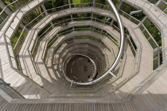 A spiral staircase with a wooden floor and metal railings