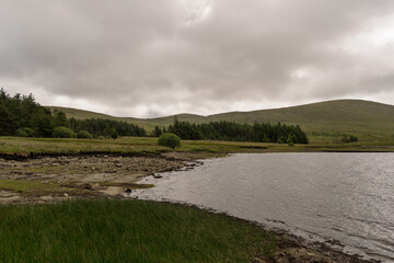 A cloudy day with a lake in the background