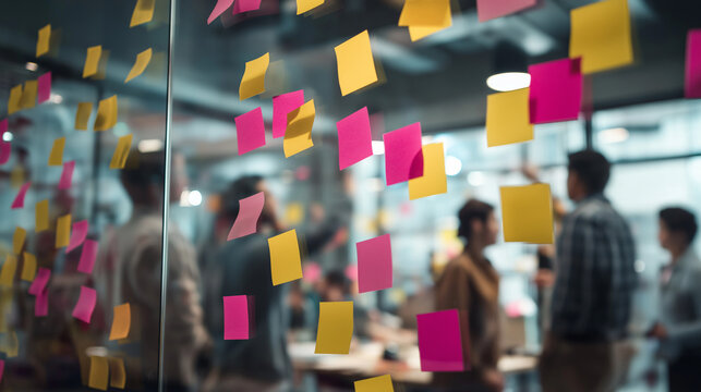 startup meeting, creative team working with sticky notes on glass wall - Powered by Adobe