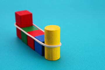 Geometric wooden figures joined with a rubber band