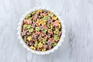 Top View Colorful Honey Stars Breakfast Cereal in White Bowl.