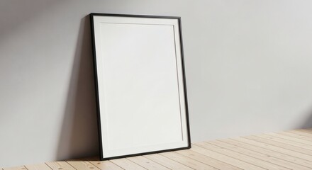 Minimalist Interior Scene: Tall Black Framed Blank Poster Leaning Against a Light Gray Wall on Wooden Floor-Mockup