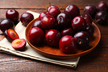 Ripe cherry plums on wooden table, closeup