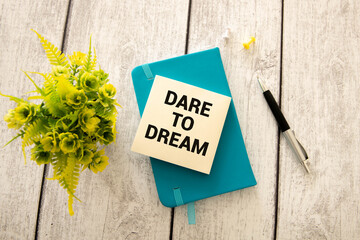 A coloured block with text DREAM, DARE, DO.