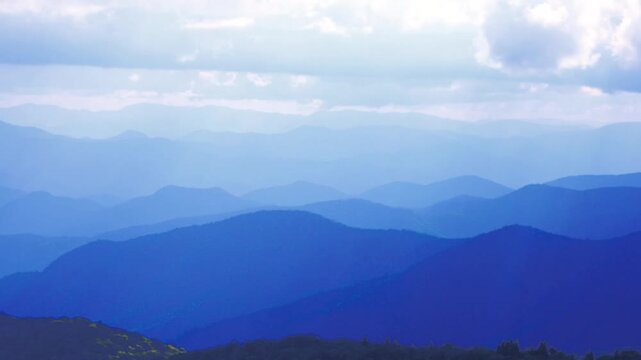 A nice mountain landscape of the layers of the Blue Ridge Mountains under a cloudy sky by Ashville, North Carolina USA.