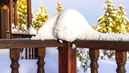 Snowy wooden porch railing