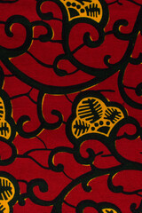 top view of red ankara fabric, flatlay of nigerian wax cloth with designs, spread out red ankara...