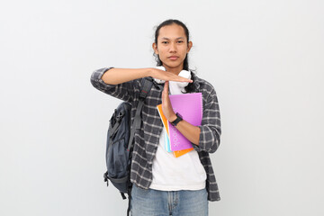 Close up photo of young Asian student making a prohibition hand gesture, wearing casual clothes,...