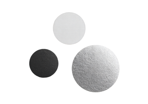Three circles of varying shades of gray and white, in a studio shot