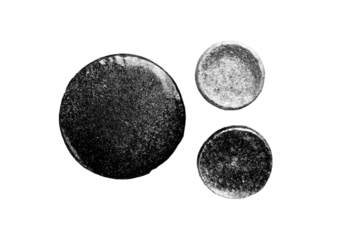 Three grayscale circular stains or droplets, textured with speckles and irregularities